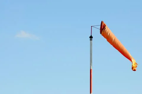 An Orange Windsock or Windvane Against the Blue Sky Stock Photos