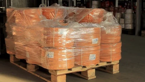 Orange wire coiled in a coil winding machine picks up and drives back Video stock 76950997