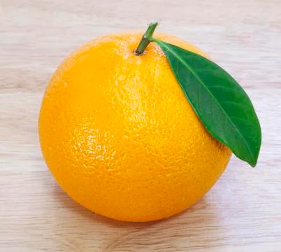 Orange on wood table Stock Photos