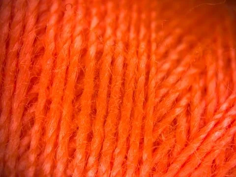 Orange yarn thread texture close up macro concept for knitting, textile industry 库存照片