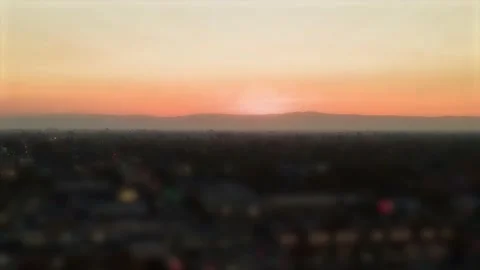 Orange Yellow Sunset behind mountains Smooth  Hyperlapse tilt shift effect Video stock 144648636