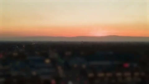 Orange Yellow Sunset behind mountains Slow  Hyperlapse tilt shift effect at Video stock 144648640