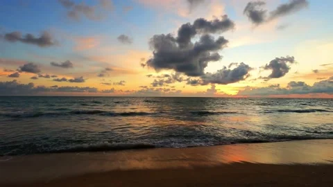 Orange yellow sunset sky over sea water reflection on beach Stock Footage 156072828