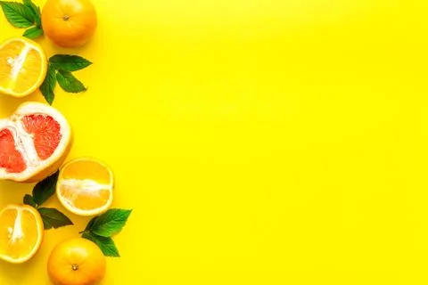 Oranges and grapefruits with leaves on table top view copy space Stock Photos