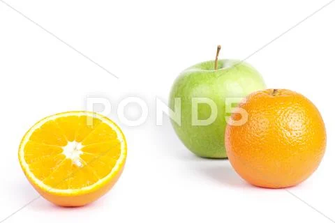 Oranges and green apple on white Stock Photos