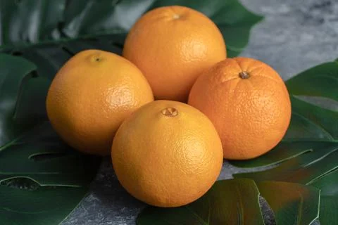 Oranges and leaves on marble background Stock Photos