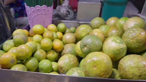 Oranges and orange juice in plastic bottles are on sale at a street stall Stock Footage 239291237