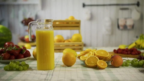 Orange's and pitcher of juice on kitchen counter near other fruit - medium, Stock Footage 341184792