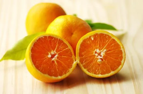 Oranges and slices on table Stock Photos