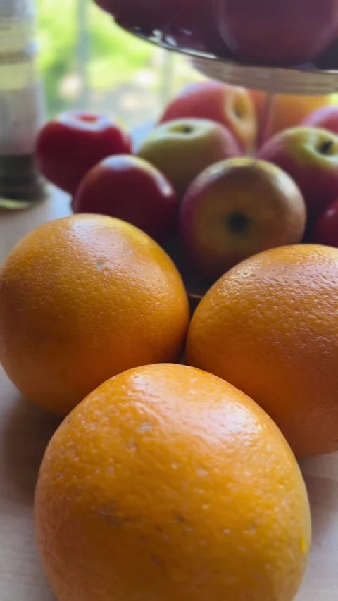 Oranges, apples and tomatoes on a kitchen table Stock Footage 276959454