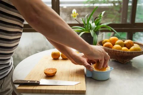 Oranges are squeezed by hand to make a pure and healthy orange juice Stock Photos