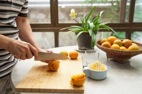 Oranges are squeezed by hand to make a pure and healthy orange juice Stock Photos