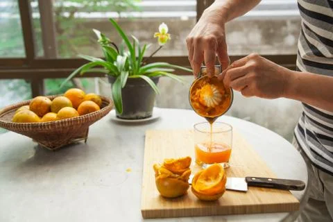 Oranges are squeezed by hand to make a pure and healthy orange juice Фото