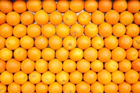 Oranges arranged in a pattern on a market display Stock Photos
