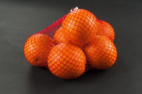 Oranges in bag mesh Stock Photos