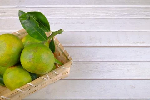 Oranges in a basket  on white table Stock Photos
