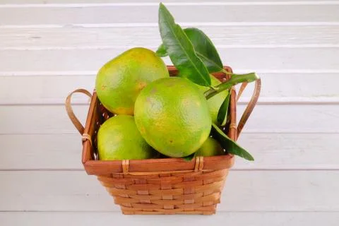Oranges in a basket  on white table Stock Photos