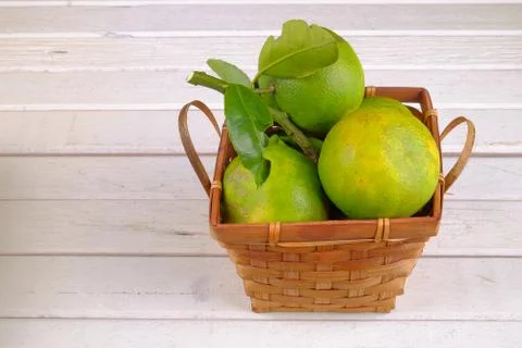 Oranges in a basket  on white table Stock Photos
