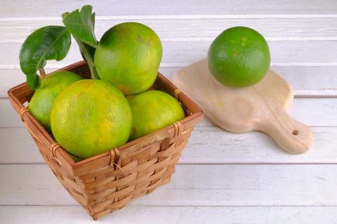 Oranges in a basket  on white table Stock Photos