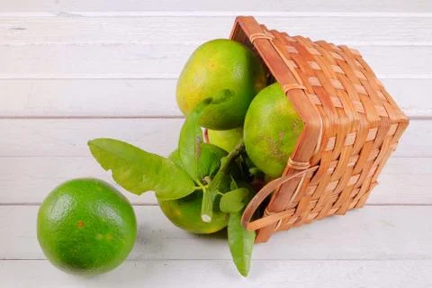 Oranges in a basket  on white table Stock Photos