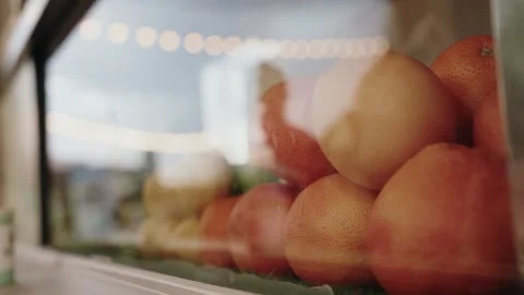 Oranges behind glass with people reflections Stock Footage 339101519