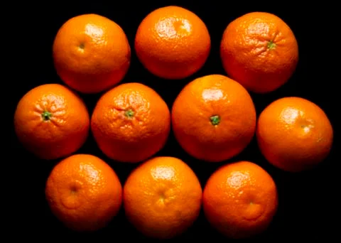 Oranges on black background Stock Photos