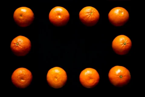 Oranges on black background Stock Photos