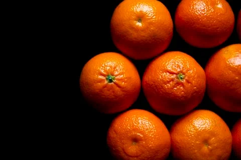 Oranges on black background Stock Photos
