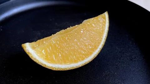 Oranges on the black plate Stock Photos