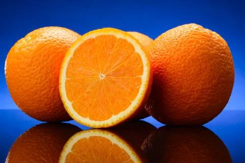 Oranges on blue background Stock Photos