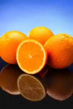 Oranges on blue background Stock Photos