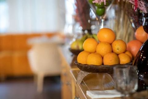Oranges in a bowl on a fruit table Stock Photos
