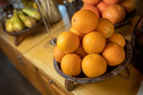Oranges in a bowl on a fruit table Stock Photos