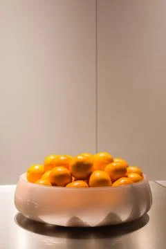 Oranges in bowl in kitchen Stock Photos