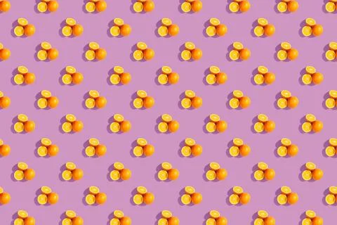 Oranges on a bright colored background. Repeating pattern, preparation for wa Stock Photos