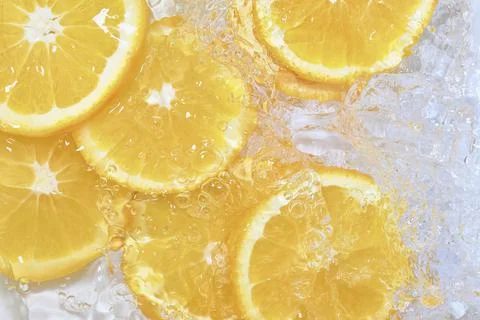 Oranges close-up in liquid with bubbles. Slices of juicy oranges in water. Close Stock-Fotos