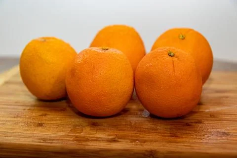Oranges on a cutting board Stock Photos