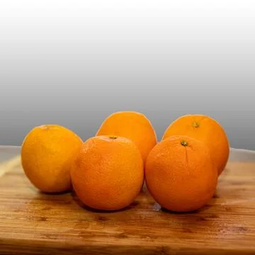 Oranges on a cutting board Stock Photos