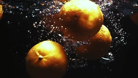Oranges Drop in Water and Create Bubbles Stock Footage 300892510