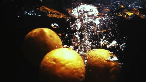 Oranges Drop in Water in Slow Motion Stock Footage 300892877