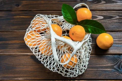 Oranges in eco mesh bag Stock Photos