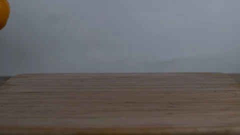 Oranges falling and bouncing on the wooden surface Stock Footage 100005879