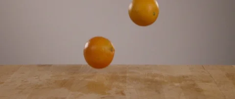 Oranges Falling Onto Cutting Board In Slow Motion 스톡 동영상 105375395