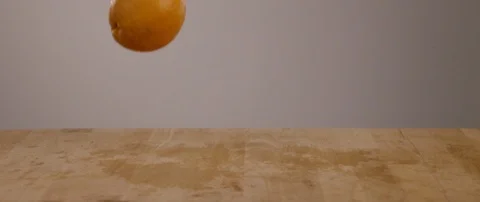 Oranges Falling Onto Cutting Board In Slow Motion 스톡 동영상 105375491