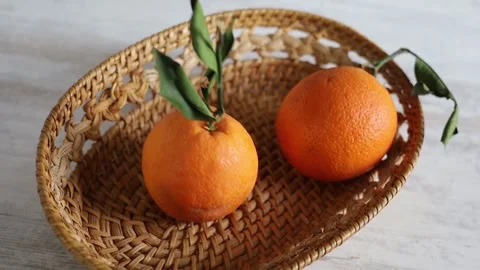 Oranges falling into wicker basket Stock Footage 170569013