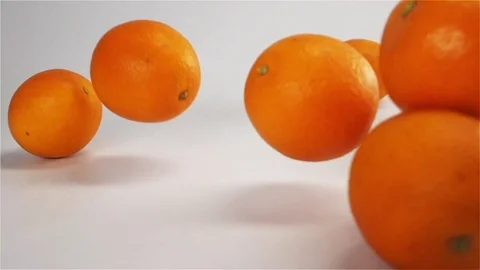 Oranges falls and bounce on white wet surface Stock Footage 75960141