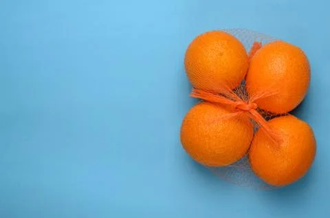 Oranges in a grid on a blue background.Copy space Stock Photos