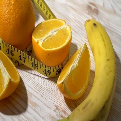 Oranges, juice, dumbbells and measuring tape on wooden background. Stock-Footage 69444553