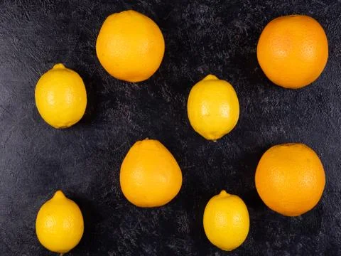 Oranges lay on black board background Stock Photos