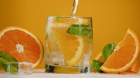 Oranges lemonade on orange background. Fruit citrus cocktail close-up texture 動画素材 196120166